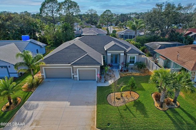 view of front of house featuring a garage and a front lawn