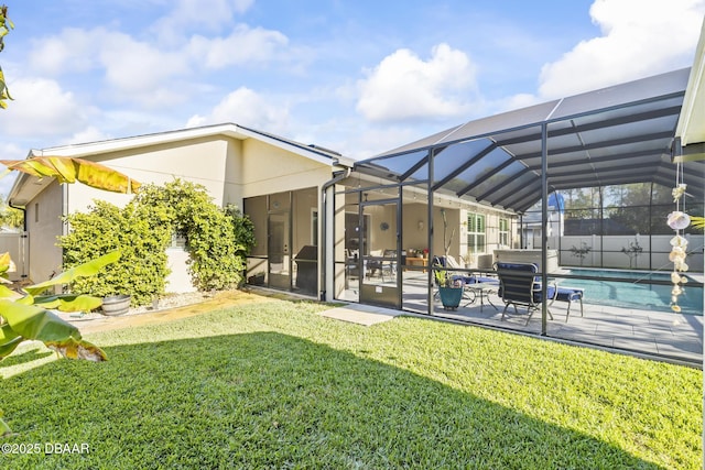 rear view of property featuring a fenced in pool, a yard, a patio, and glass enclosure