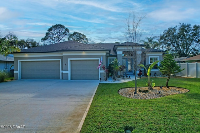 view of front of property with a garage and a front lawn