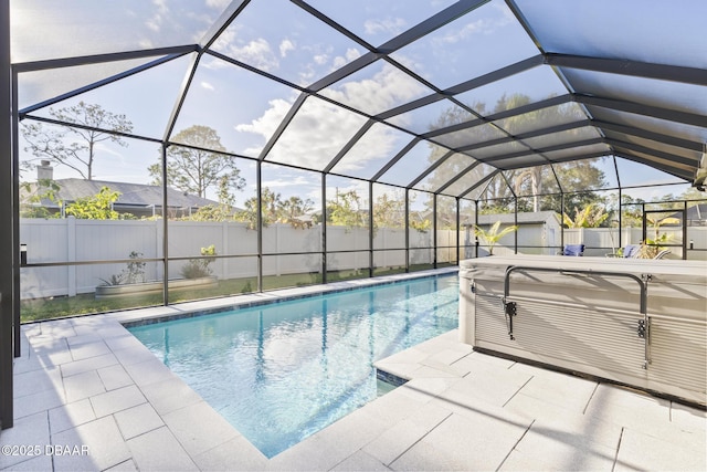 view of pool with a patio area and glass enclosure