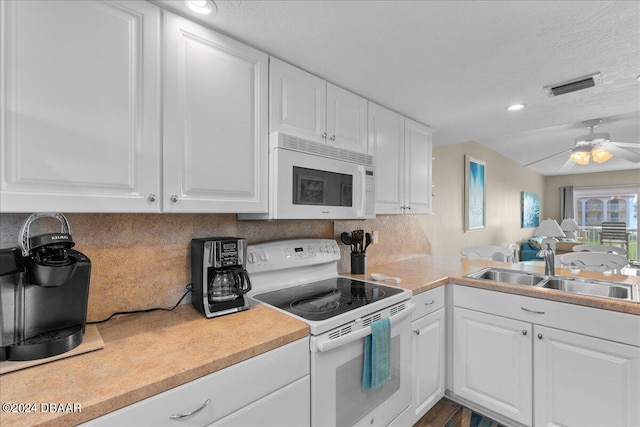 kitchen featuring white appliances, sink, and white cabinets