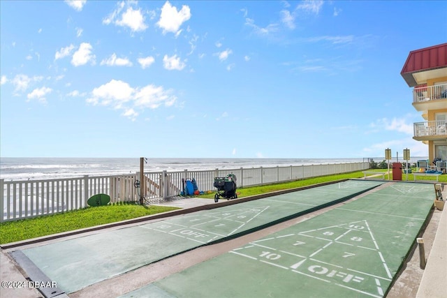 surrounding community featuring a water view and a beach view