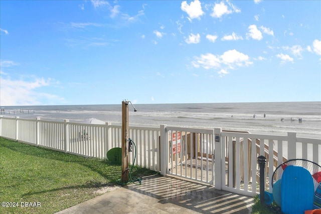 exterior space featuring a water view and a beach view