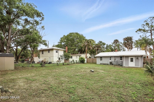 view of yard with a fenced backyard and an outbuilding