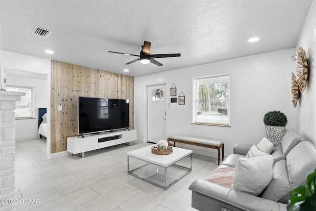 living room featuring recessed lighting, plenty of natural light, and a ceiling fan