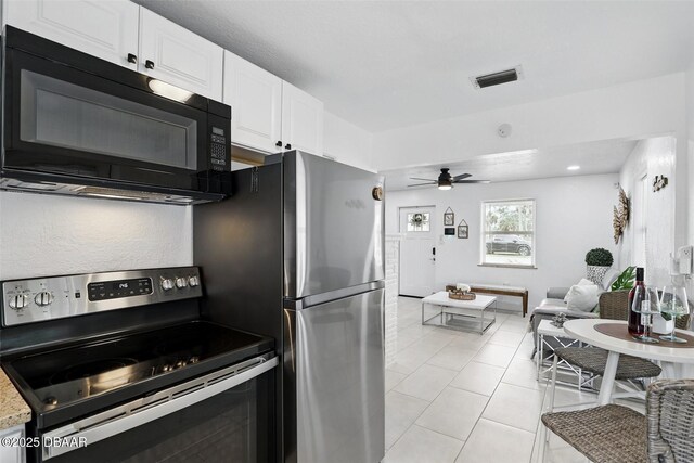 kitchen with light tile patterned flooring, ceiling fan, stainless steel appliances, white cabinetry, and visible vents