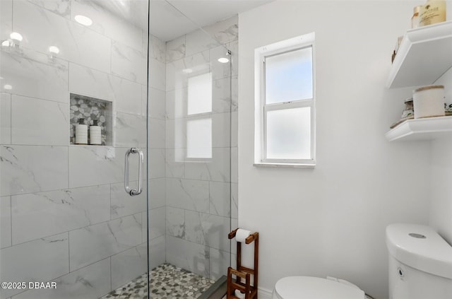 full bathroom with a shower stall and toilet