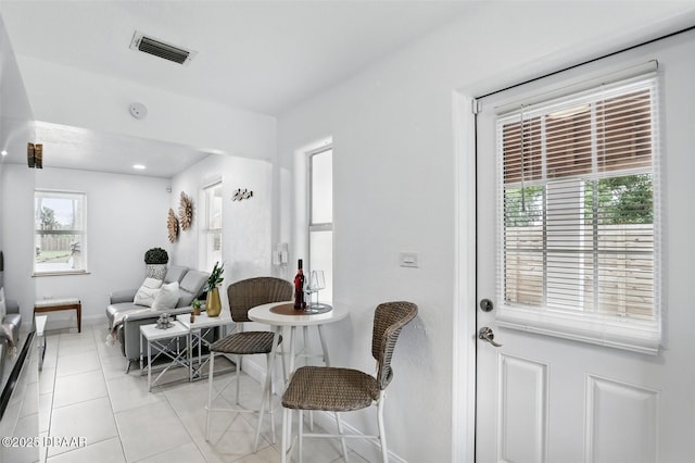 dining area featuring baseboards, visible vents, and light tile patterned floors