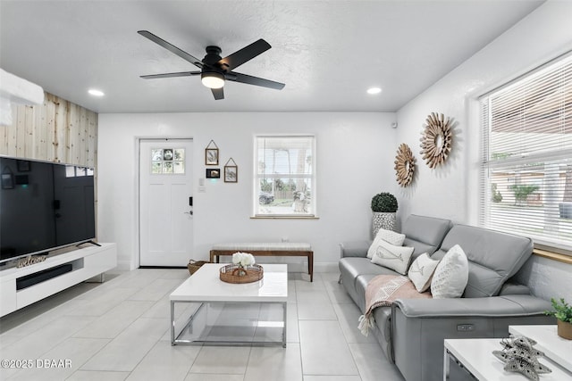 living area featuring light tile patterned floors, baseboards, recessed lighting, and ceiling fan