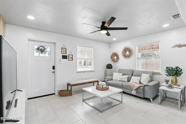 living room with recessed lighting, a textured ceiling, visible vents, and ceiling fan