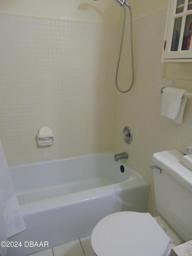 bathroom featuring tile patterned floors, toilet, and shower / tub combo with curtain