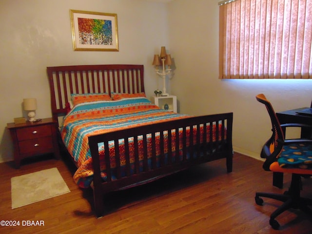 bedroom with wood-type flooring