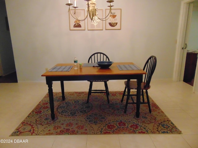 dining space with a chandelier and tile patterned floors