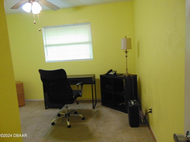 carpeted home office with ceiling fan