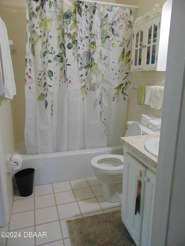 full bathroom featuring tile patterned flooring, vanity, toilet, and shower / bath combo with shower curtain