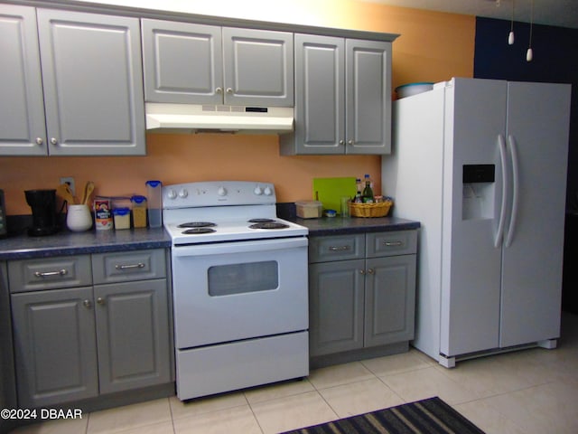 kitchen featuring gray cabinets, light tile patterned floors, and white appliances