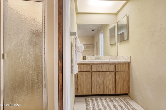 bathroom featuring tile patterned flooring and vanity