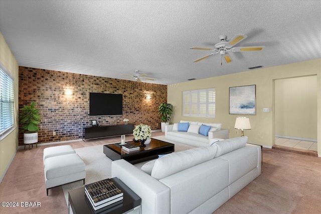 living room featuring brick wall, carpet flooring, ceiling fan, and plenty of natural light