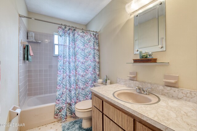 full bathroom with toilet, vanity, and shower / bath combination with curtain