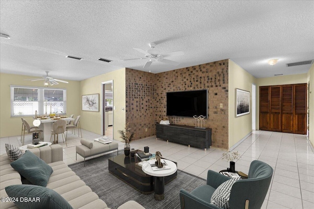 tiled living room with a textured ceiling and ceiling fan