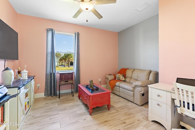 living room with ceiling fan and light wood-type flooring