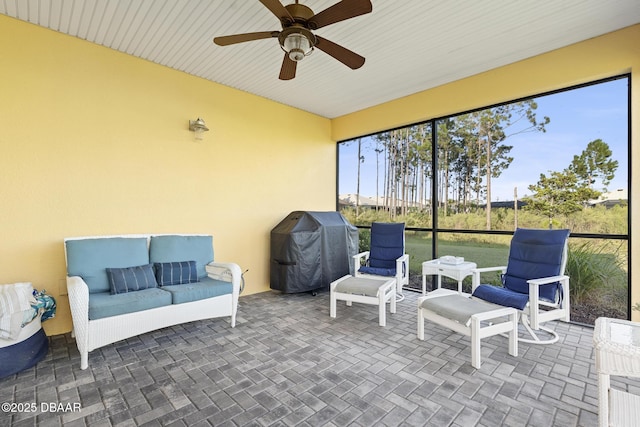 sunroom featuring ceiling fan