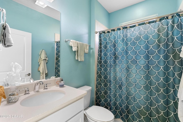 bathroom with vanity, toilet, and curtained shower