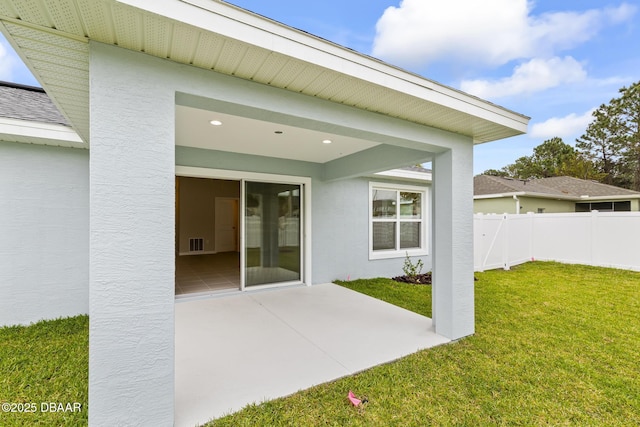 exterior space with visible vents, a patio, and fence