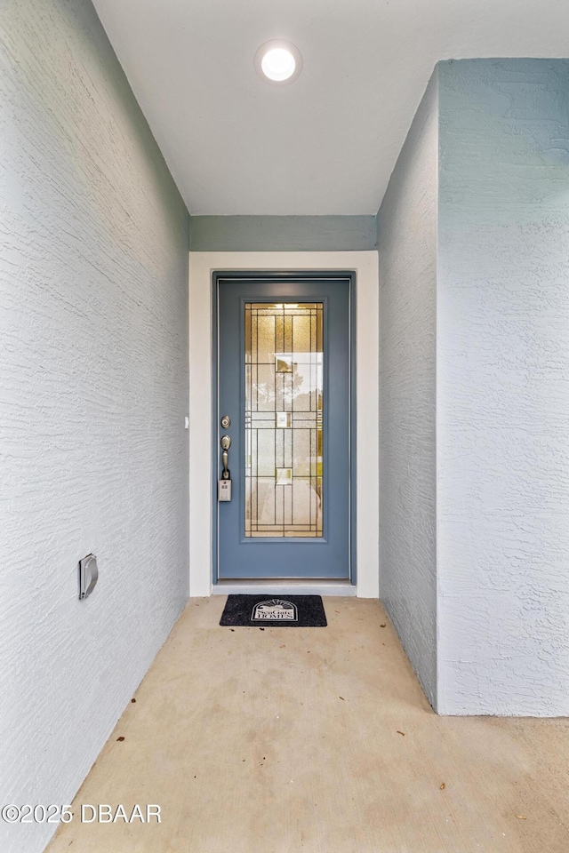 property entrance featuring stucco siding