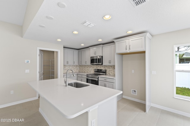 kitchen with visible vents, plenty of natural light, appliances with stainless steel finishes, and a sink