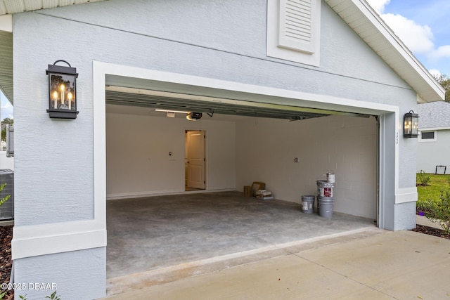 garage featuring a garage door opener and concrete driveway