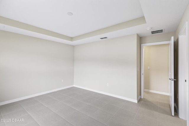 spare room with light tile patterned floors, baseboards, and visible vents