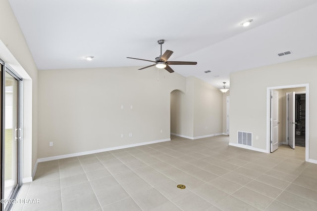 empty room with visible vents, baseboards, a ceiling fan, and vaulted ceiling