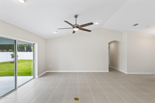 spare room with visible vents, baseboards, lofted ceiling, arched walkways, and a ceiling fan