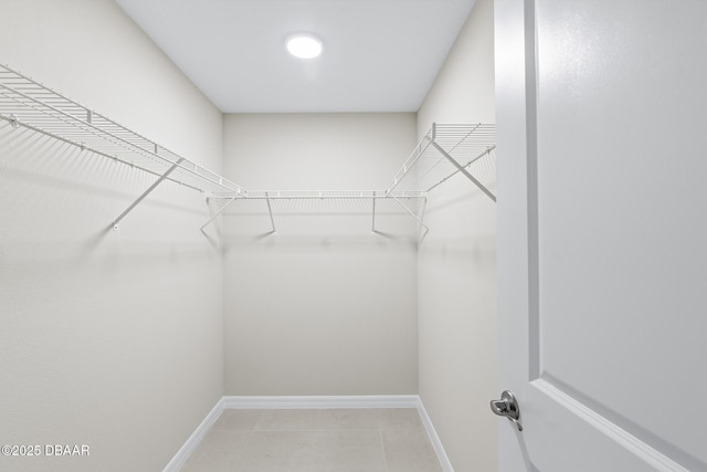 walk in closet featuring light tile patterned floors