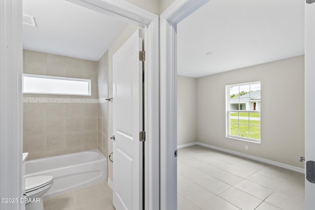 full bathroom with baseboards, visible vents,  shower combination, tile patterned flooring, and toilet