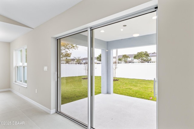 doorway to outside featuring baseboards