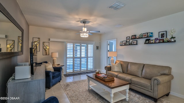 tiled living room with ceiling fan