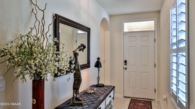 foyer entrance with light tile patterned flooring