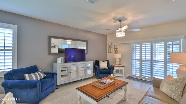 tiled living room featuring ceiling fan