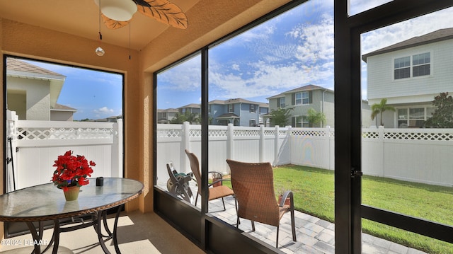 sunroom / solarium featuring ceiling fan