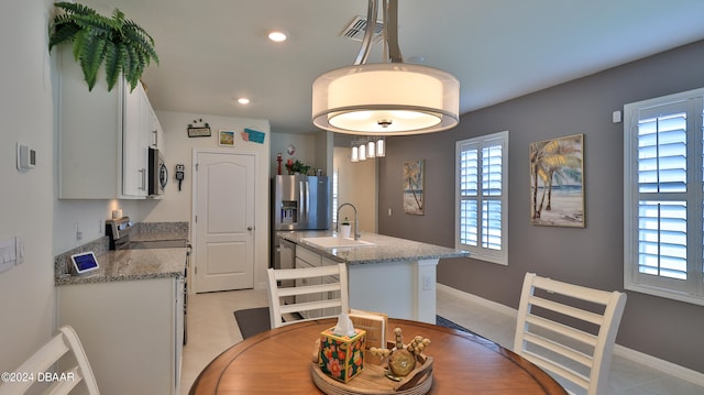 dining space with a wealth of natural light and sink