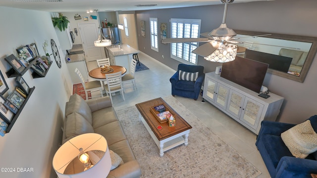 tiled living room with ceiling fan and vaulted ceiling