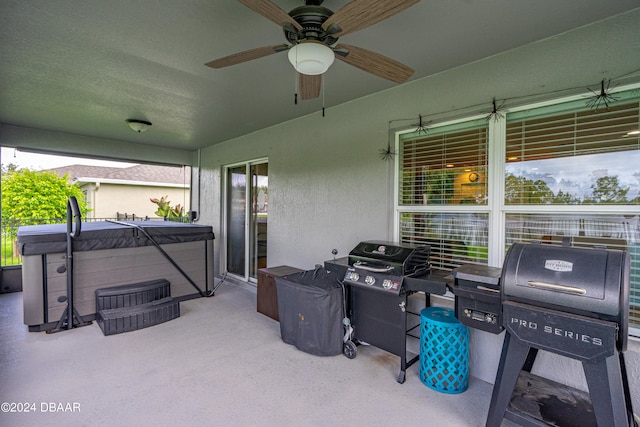 view of patio with a hot tub and ceiling fan