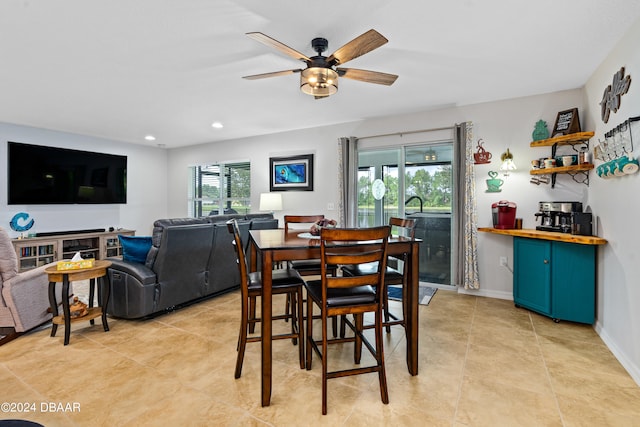 tiled dining room featuring a wealth of natural light and ceiling fan