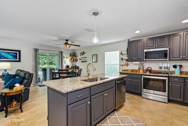 kitchen with stainless steel appliances, gray cabinets, a healthy amount of sunlight, and sink