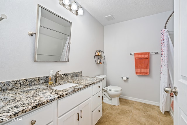 bathroom featuring toilet, vanity, a textured ceiling, and walk in shower