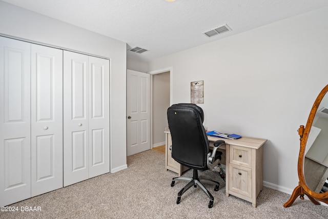 office featuring light colored carpet and a textured ceiling