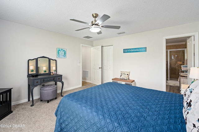 carpeted bedroom with a textured ceiling, ceiling fan, and connected bathroom