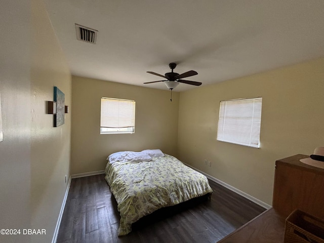 bedroom with ceiling fan and dark hardwood / wood-style flooring